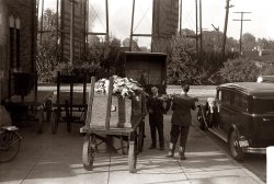 October 1938. Shelbyville, Indiana. Hearse meeting casket at railroad station. View full size. 35mm nitrate negative by John Vachon.
