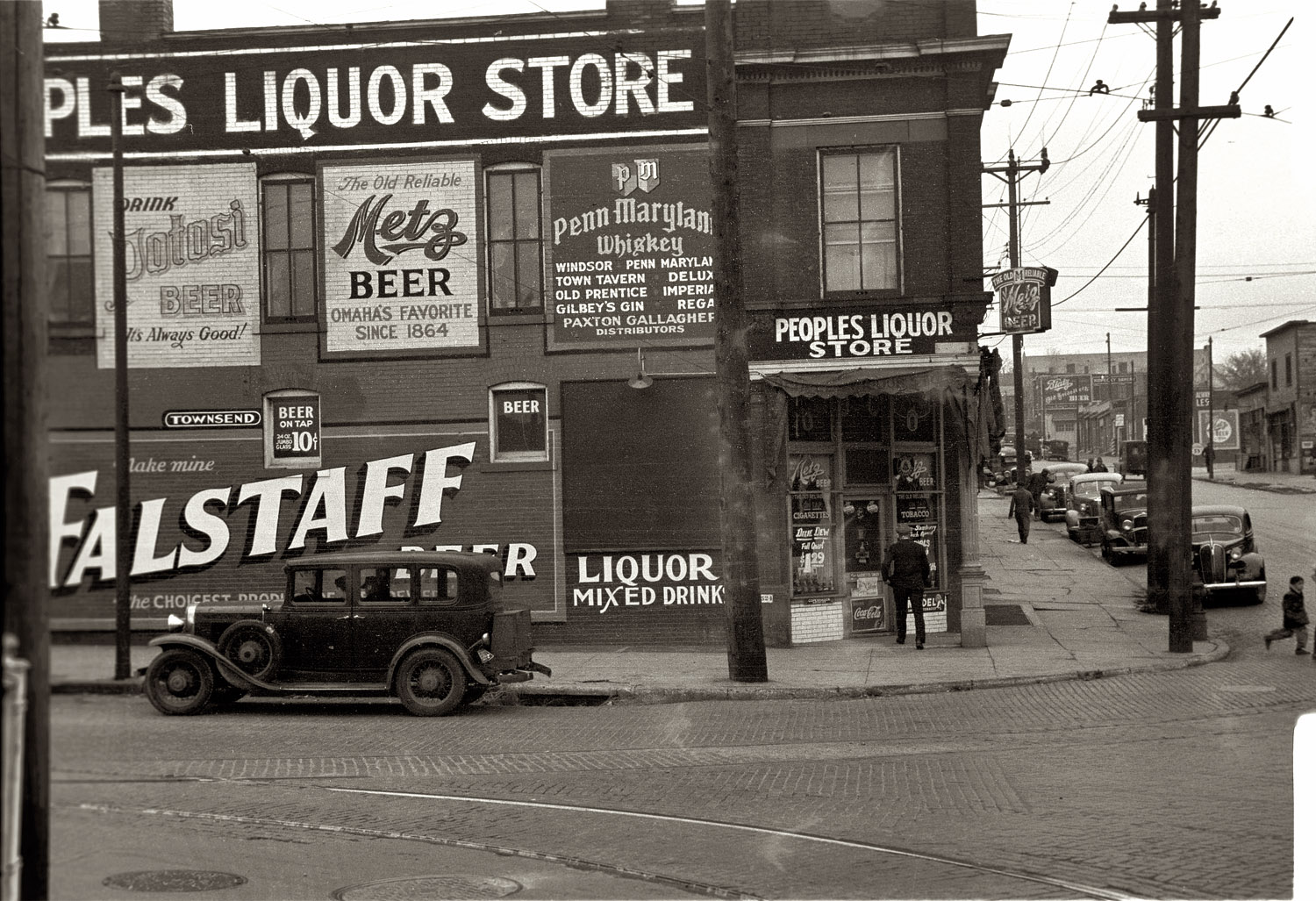 November 1938. Liquor store in Omaha, Nebraska. View full size. 35mm nitrate negative by John Vachon for the Farm Security Administration.