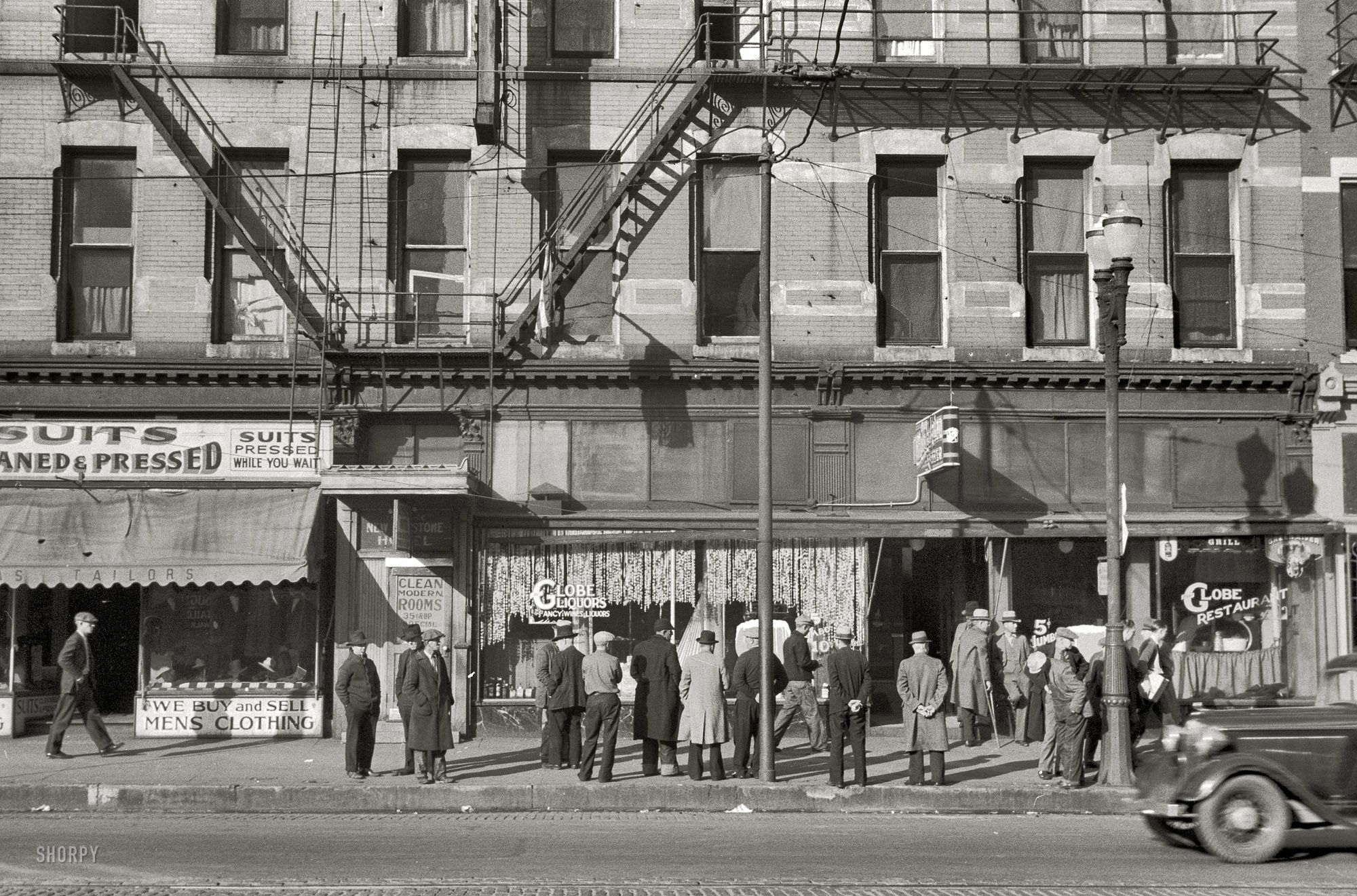 November 1938. Omaha, Nebraska. "Lower Douglas Street, where the unemployed hang out." 35mm negative by John Vachon. View full size. 