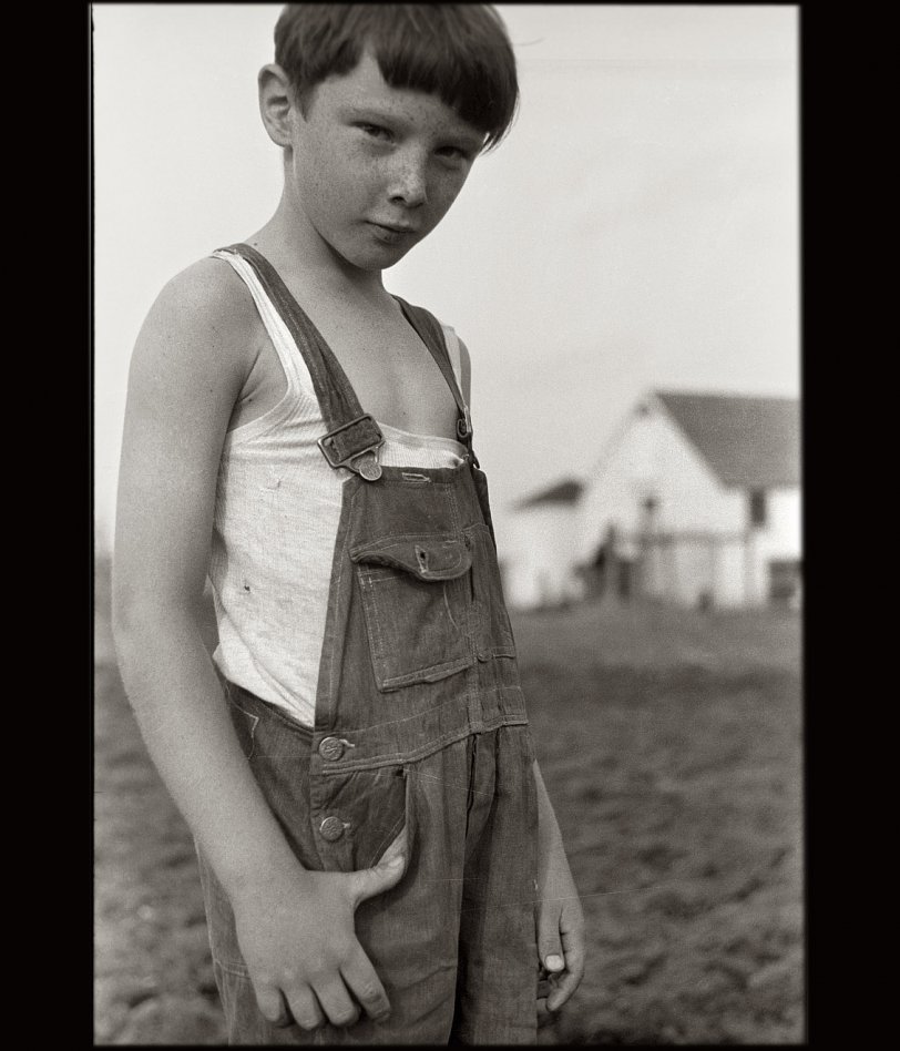 Making his third appearance here in as many days, the impish Iowa farmboy captured on film by John Vachon in May 1940. View full size.
