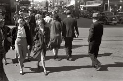 May 1940. "Afternoon, downtown Des Moines, Iowa." View full size. 35mm nitrate negative by John Vachon for the Farm Security Administration.
All Together NowNow all together, put your right foot forward.  Hmnnn, how did Busby Berkeley, I mean John Vachon ever get all them folks to synchronize like that, now that's a photographer.
Des MoinesDoes anyone know where in Des Moines this is? I'm sure it's downtown. I tried to search for Hotel Franklin, but came up with nothing.
[The Hotel Franklin was at Fifth and Locust. - Dave]
Hotel FranklinThe image is looking north on 5th Avenue at Locust. One can tell the direction and street by the bend in the road in the near distance. In the downtown area, only streets on the north edge (mostly numbered streets) bend that way.
The Franklin Hotel became a rat trap by the '70s and was torn down toward the end of that decade or in the 1980s.
The people look reasonably well-dressed, but so thin -- almost gaunt in some cases. Busby Berkeley indeed.
(The Gallery, John Vachon)