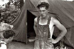 July 1940. Migrant cherry picker in front of tent home. Berrien County, Michigan. View full size. 35mm nitrate negative by John Vachon for the FSA.