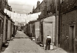 July 1938. Back alley showing housing conditions in Ambridge, Pennsylvania. View full size. 35mm nitrate negative by Arthur Rothstein for the FSA.