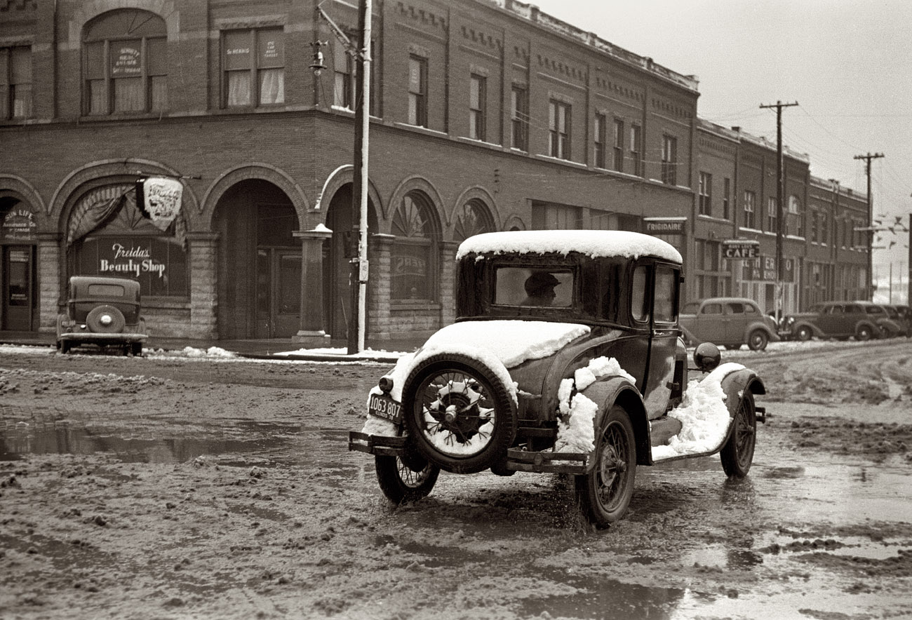 January 1939. Navigating the business district of Herrin, Illinois, after a snowstorm. View full size. 35mm nitrate negative by Arthur Rothstein.