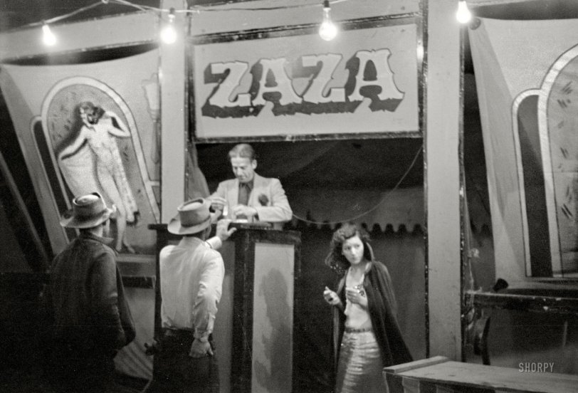 Summer 1939. "Amusements at carnival, Bozeman, Montana." Zaza in Bozeman -- has a certain ring to it, no? But we digress. Pony up a dime or move along. 35mm negative by Arthur Rothstein, Resettlement Administration. View full size. 
