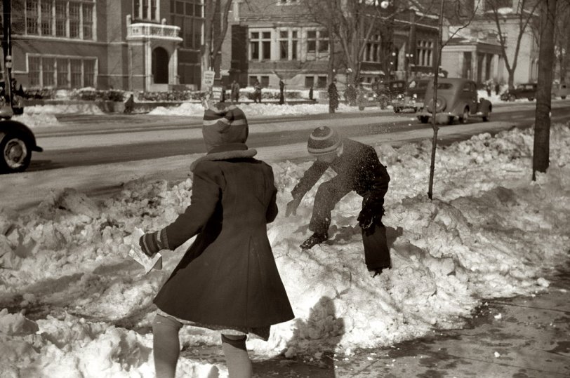 February 1940. A roadside snowball fight in Chillicothe, Ohio. View full size. 35mm nitrate negative by Arthur Rothstein. A reminder from the Shorpy Art Store: Place your order soon for regular delivery by December 25. We also have an Express Mail delivery option. Recent distinguished purchaser: The New York Times, for 30 x 22 prints to decorate its new Manhattan headquarters. 