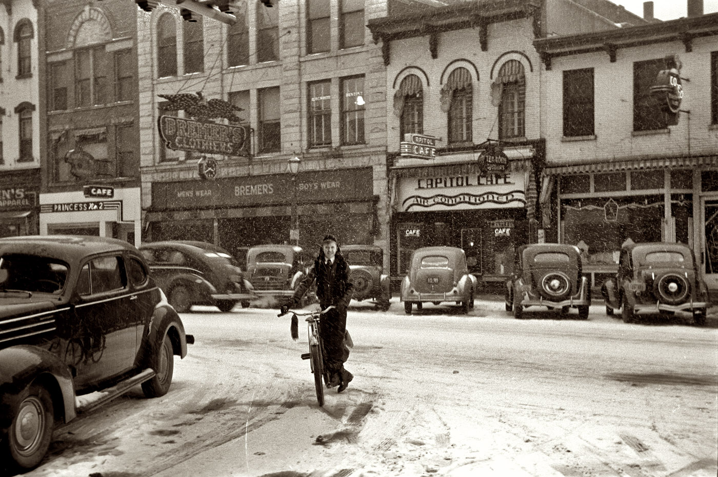 February 1940. The main street in Iowa City during a snowstorm. View full size. Businesses in this view include Bremer's, the Capitol Cafe and Princess No. 2. 35mm nitrate negative by Arthur Rothstein for the Farm Security Administration.