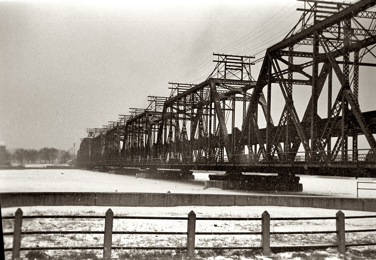 February 1940. Government Bridge (or Arsenal Bridge) across the Mississippi River at Davenport, Iowa, on a snowy day. View full size. 35mm nitrate negative by Arthur Rothstein for the Farm Security Administration.