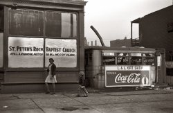 April 1941. Storefront church and adjacent lunch wagon in the Chicago Black Belt. View full size. 35mm nitrate negative by Edwin Rosskam.