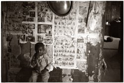 Interior of tenant farmer home. Little Rock, Arkansas. October 1935. The "round thing" is an old-fashioned convex mirror. View full size. Photo by Ben Shahn.