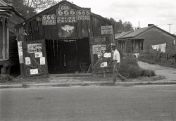 October 1935. "Advertisements for popular malaria cure. Natchez, Mississippi." Photo by Ben Shahn for the Farm Security Administration. View full size.