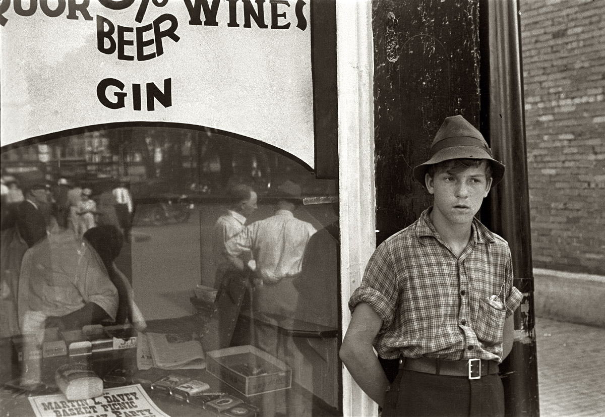 Summer 1938. Newark, Ohio. "Boy in front of liquor store."  View full size. 35mm nitrate negative by Ben Shahn for the Farm Security Administration.