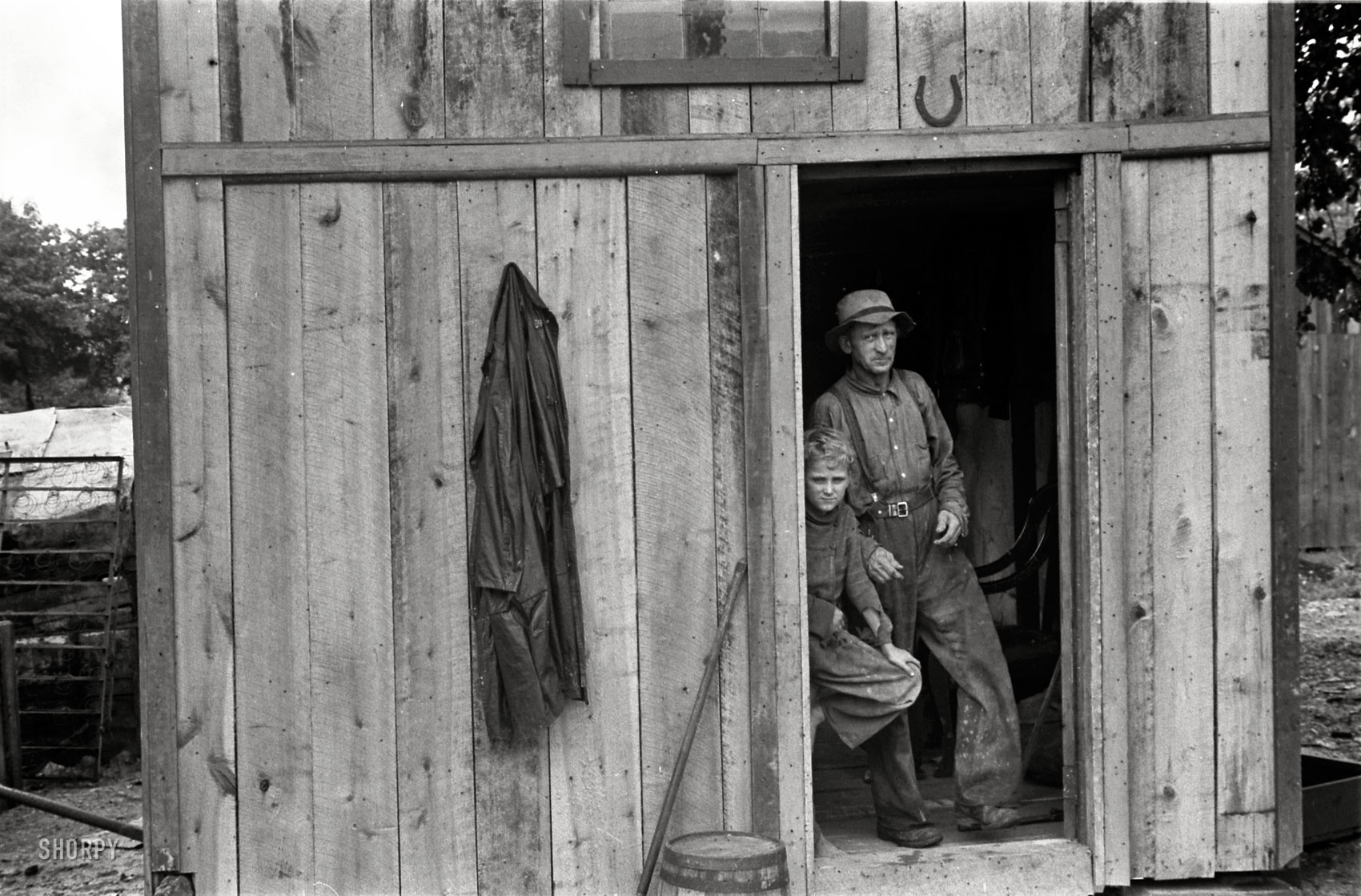 Summer 1938. Circleville, Ohio. "Dwellers in Circleville's 'Hooverville.' During Depression many farms of the district were foreclosed. People who lost homes naturally gravitated toward the town. A town of its character is unable to house new influx of population. Consequently there sprang up around it an extensive Hooverville." 35mm nitrate negative by Ben Shahn. View full size.