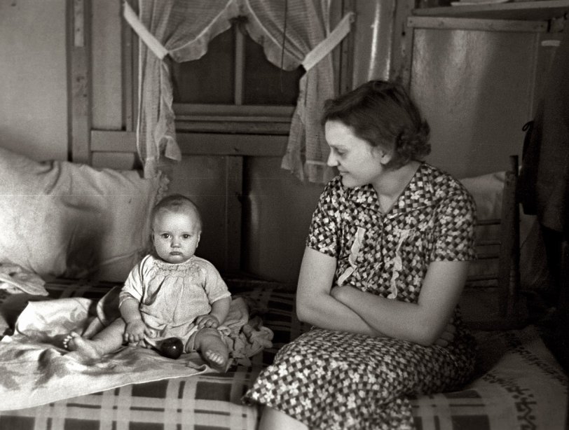 December 1936. "Mrs. Charles Benning and baby in their shack home at Shantytown. Spencer, Iowa." View full size. 35mm negative by Russell Lee.
