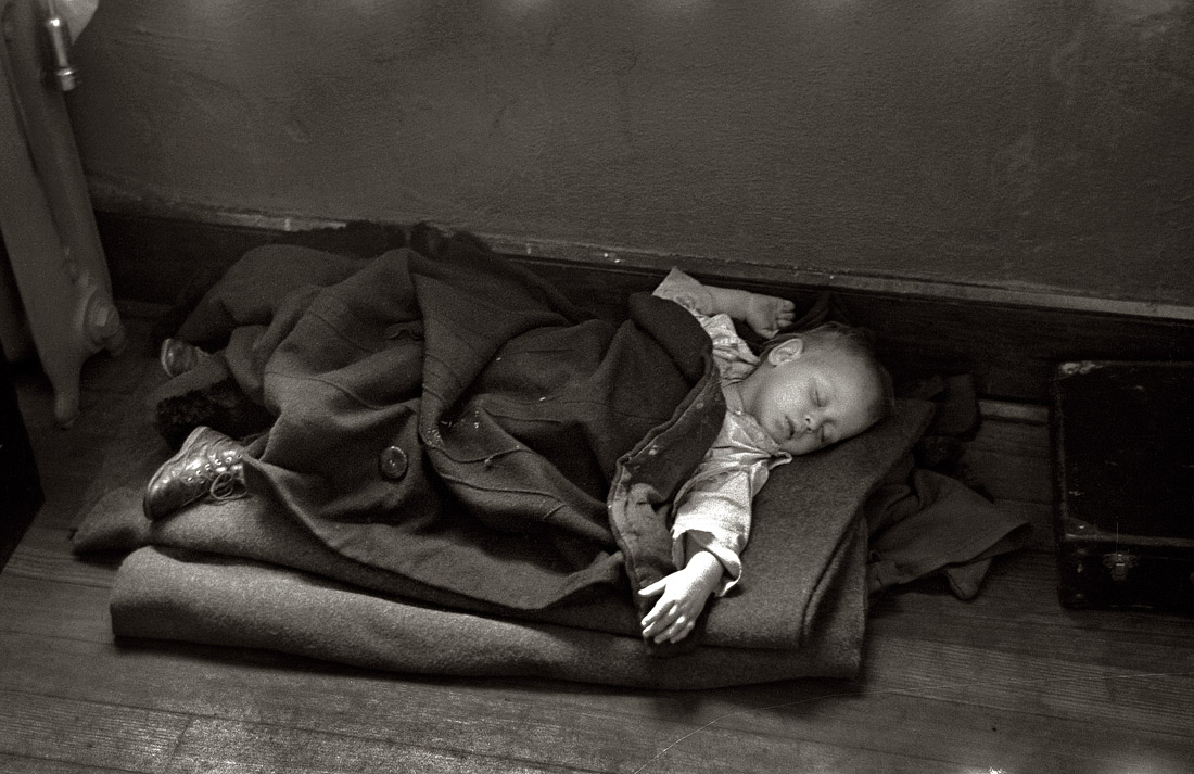 January 1937. Young flood refugee asleep in a schoolhouse at Sikeston, Missouri. View full size. 35mm nitrate negative by Russell Lee, Farm Security Administ'n.