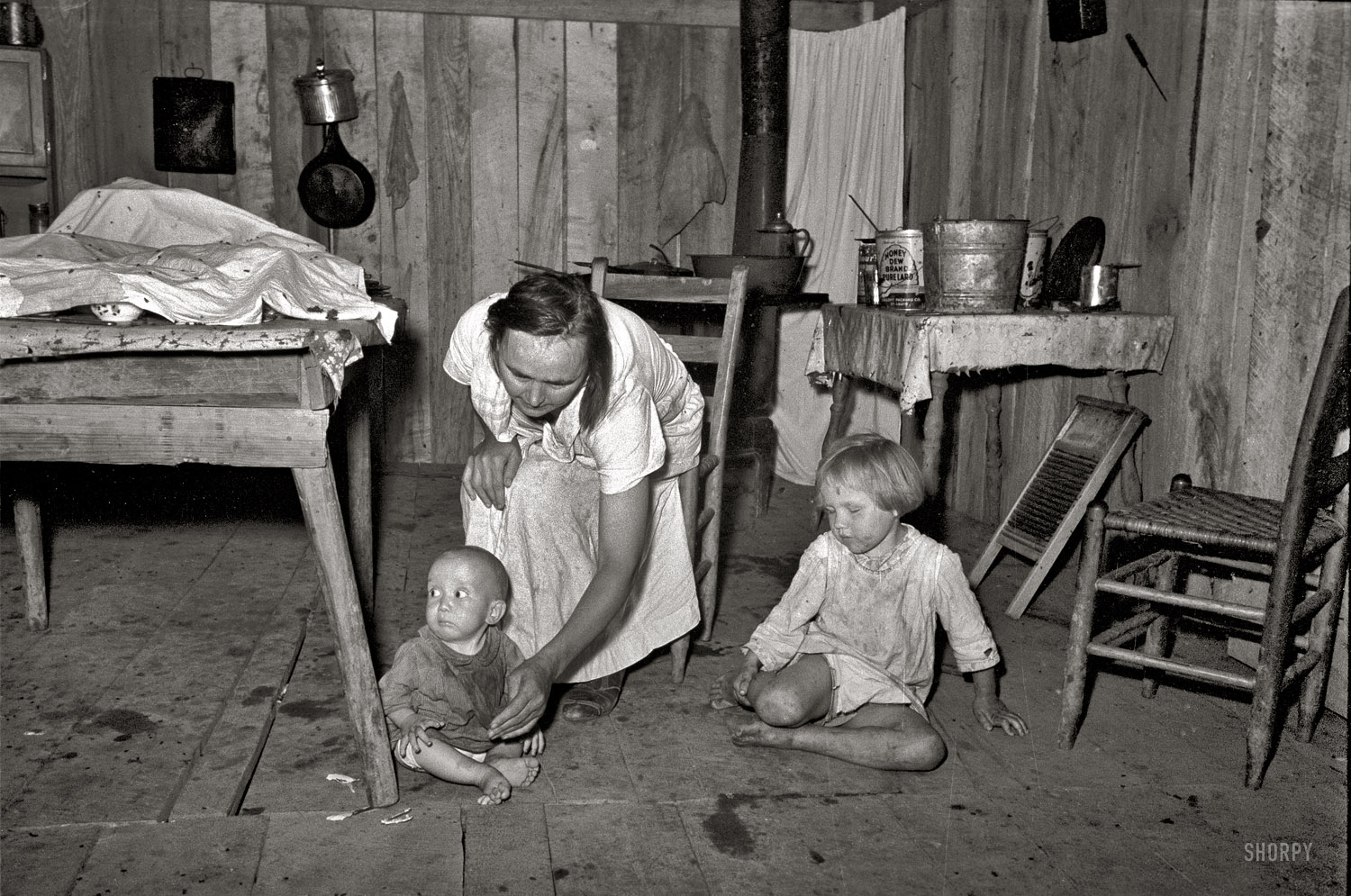 May 1938. New Madrid County, Missouri. "Interior of house without windows, home of sharecropper, cut-over farmer of Mississippi bottoms." 35mm nitrate negative by Russell Lee for the Farm Security Administration. View full size.