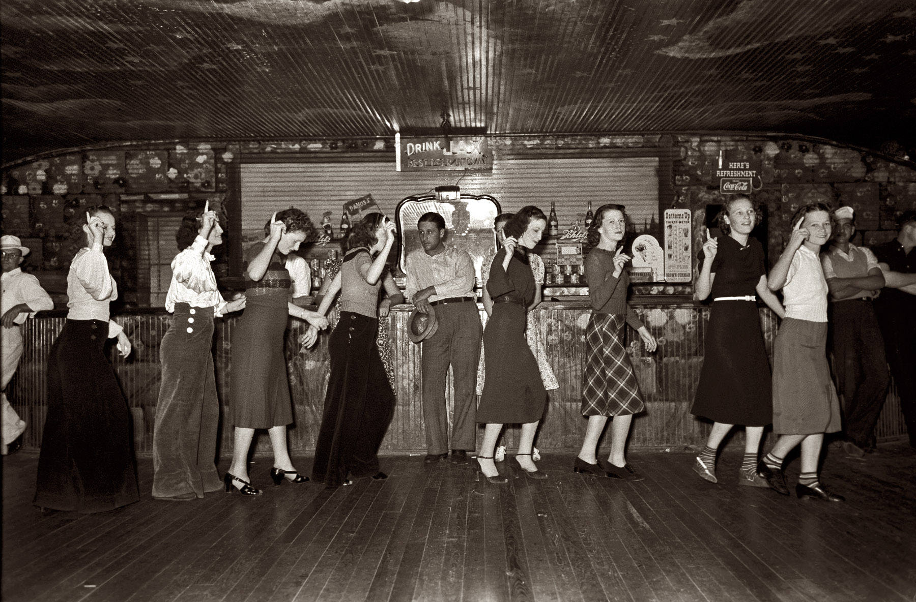 October 1938. "Roadhouse. Raceland, Louisiana. Girls at Dano's for free Friday night crab boil." View full size. 35mm negative by Russell Lee for the FSA.