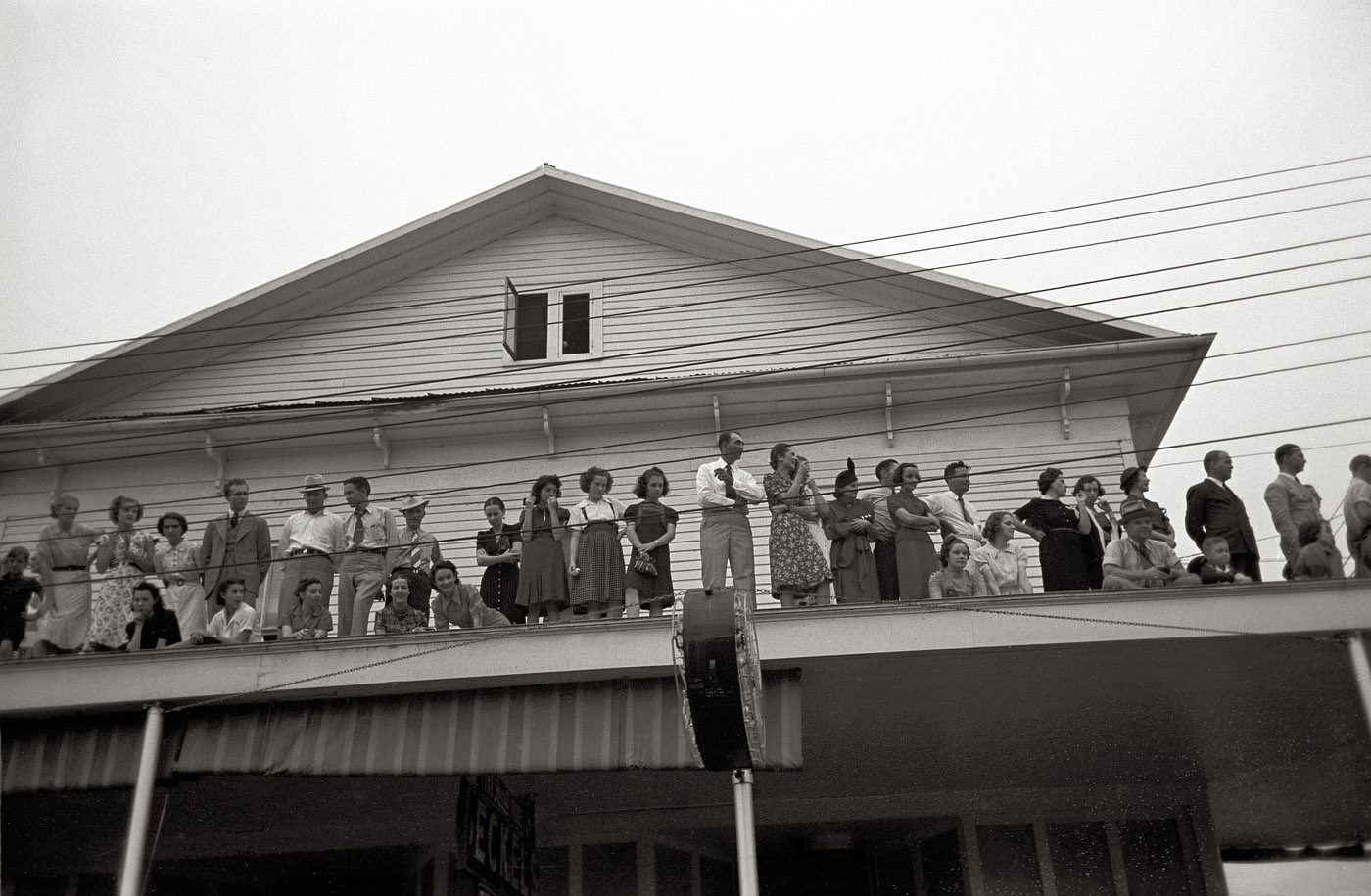 October 1938. "Group of people on roof watching parade at the National Rice Festival. Crowley, Louisiana." View full size. 35mm nitrate negative by Russell Lee for the Farm Security Administration. Library of Congress.