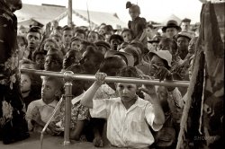 Noevember 1938. Children at the state fair in Donaldsonville, Louisiana. 35mm negative by Russell Lee for the Farm Security Administration. View full size.
Black and WhiteThis is the deep South but the crowd does not seem at all segregated. Perhaps because they are children?
[Click here. Maybe you've been watching too much TV. - Dave]
(The Gallery, Kids, Russell Lee)