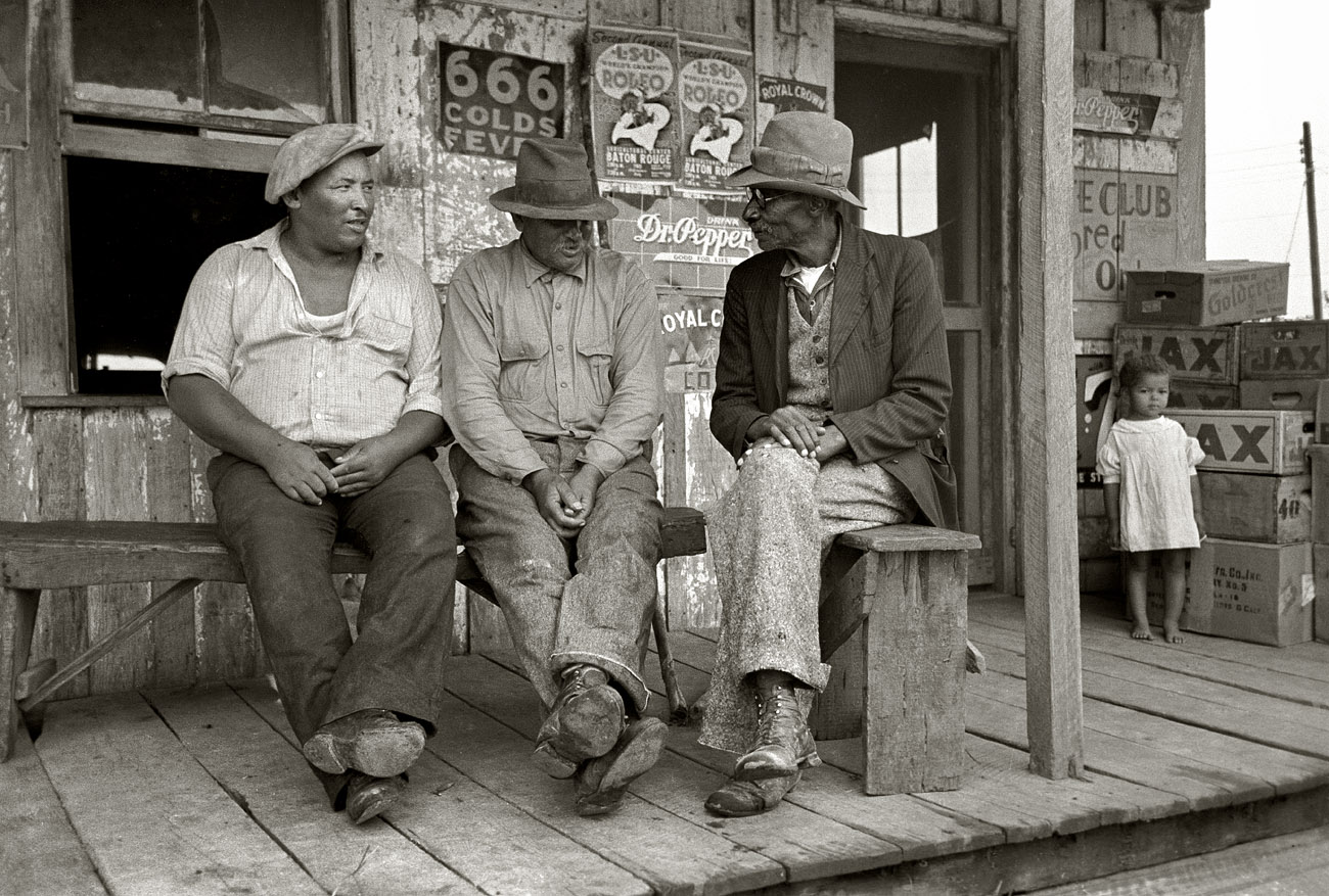 October 1938. "Porch of small Negro store near Jeanerette, Louisiana." 35mm negative by Russell Lee for the Farm Security Administration. View full size.