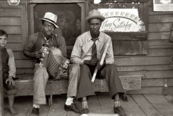 October 1938. Musicians playing accordion and washboard in front of a store near New Iberia, Louisiana, the home of Tabasco pepper sauce. View full size. 35mm nitrate negative by Russell Lee for the Farm Security Administration.
