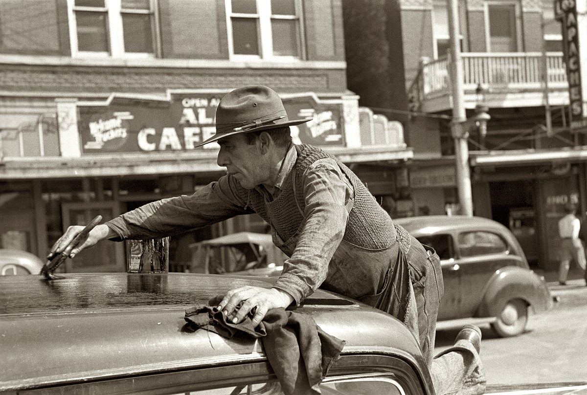March 1939. San Antonio, Texas. "Man painting automobile top near market." View full size. 35mm negative by Russell Lee, Farm Security Administration.