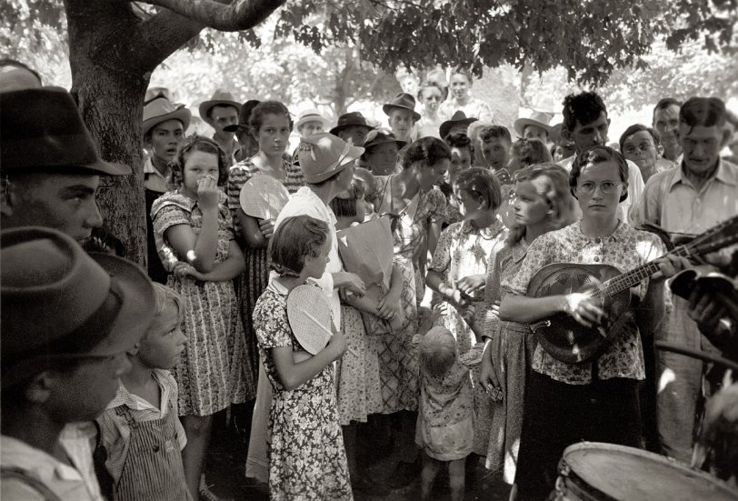 July 1939. "Group of people assembled under tree to listen to revival rally on Saturday afternoon. Tahlequah, Oklahoma." View full size. 35mm nitrate negative by Russell Lee for the Farm Security Administration.