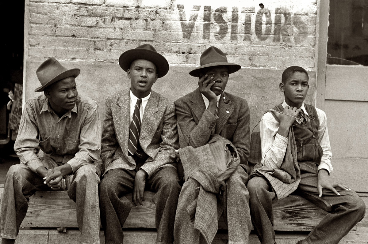November 1939. "Negro boys sitting on bench on street, Waco, Texas." 35mm negative by Russell Lee for the Farm Security Administration. View full size.