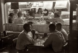 "Cold drinks on the Fourth of July" at the Red Robin Coffee Shop in Vale, Oregon. The year was 1941. Can we stay just a little longer? View full size. 35mm nitrate negative by Russell Lee for the Farm Security Administration.