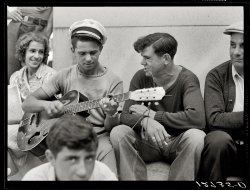August 1940. "Local talent makes music on a Sunday afternoon under the soldiers' monument. Provincetown, Massachusetts." View full size. Medium-format safety negative by Edwin Rosskam for the Farm Security Administration.