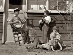 February 1942. Weslaco, Texas. Younger members of the Drake family, including the young man shown playing at the barn dance elsewhere in today's posts, at the Farm Security Administration's Mercer Evans camp. Acetate negative by Arthur Rothstein for the FSA. View full size. Update: The banjo player is Jasper "Sleepy" Drake; his sister Monnie is the guitarist.  