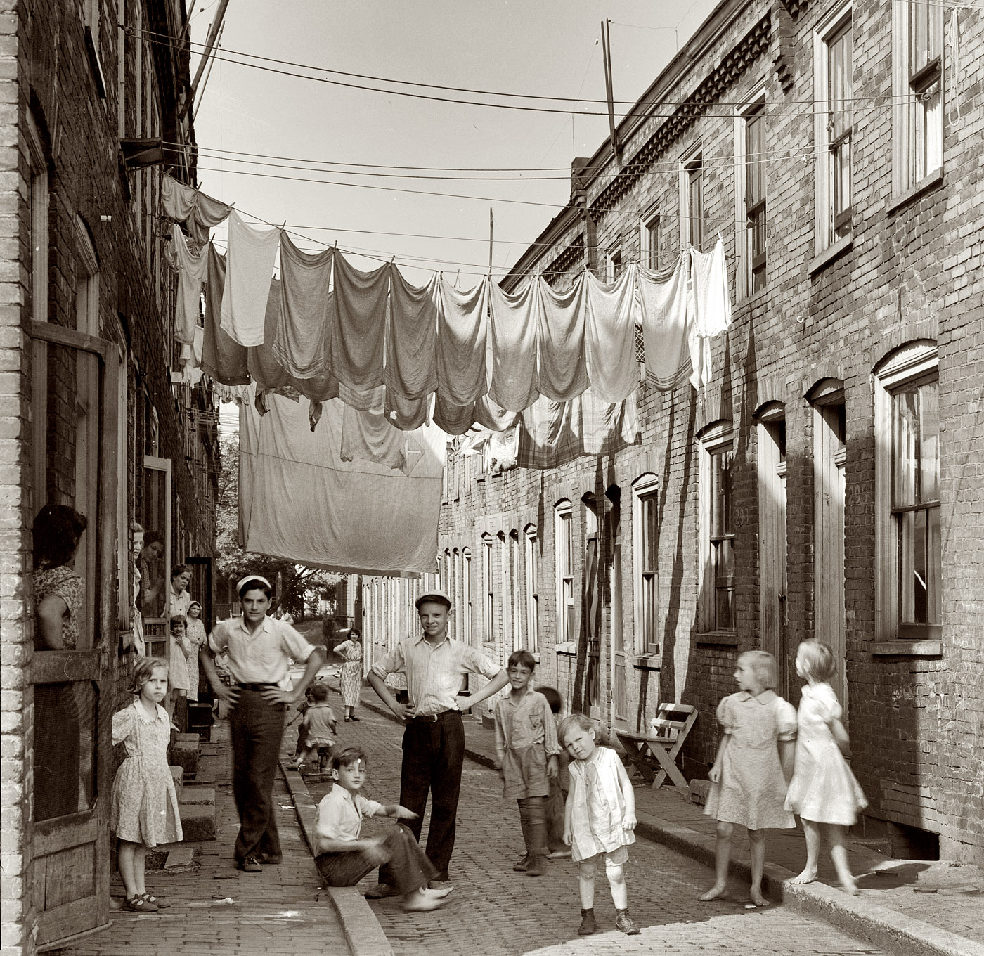 July 1938. Another view of "housing conditions in Ambridge, Pennsylvania, home of the American Bridge Company." View full size. Photo by Arthur Rothstein. While I guess the point here is the decrepit nature of the neighborhood, it looks to have been a great place to grow up. Like something from a Neil Simon play.