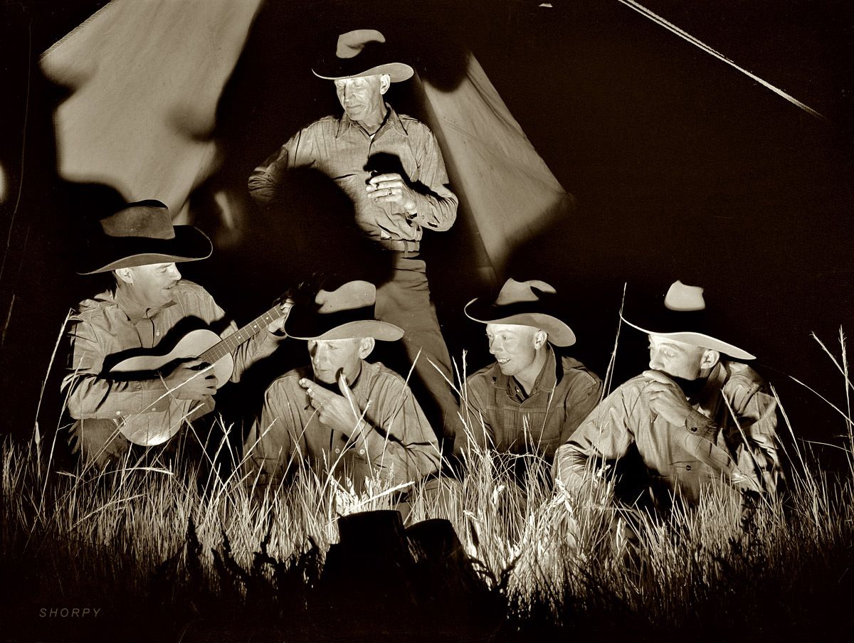 June 1939. Big Horn County, Montana. "Cowhands singing after day's work. Quarter Circle U Ranch roundup." Medium format acetate negative by Arthur Rothstein for the Farm Security Administration. View full size.
