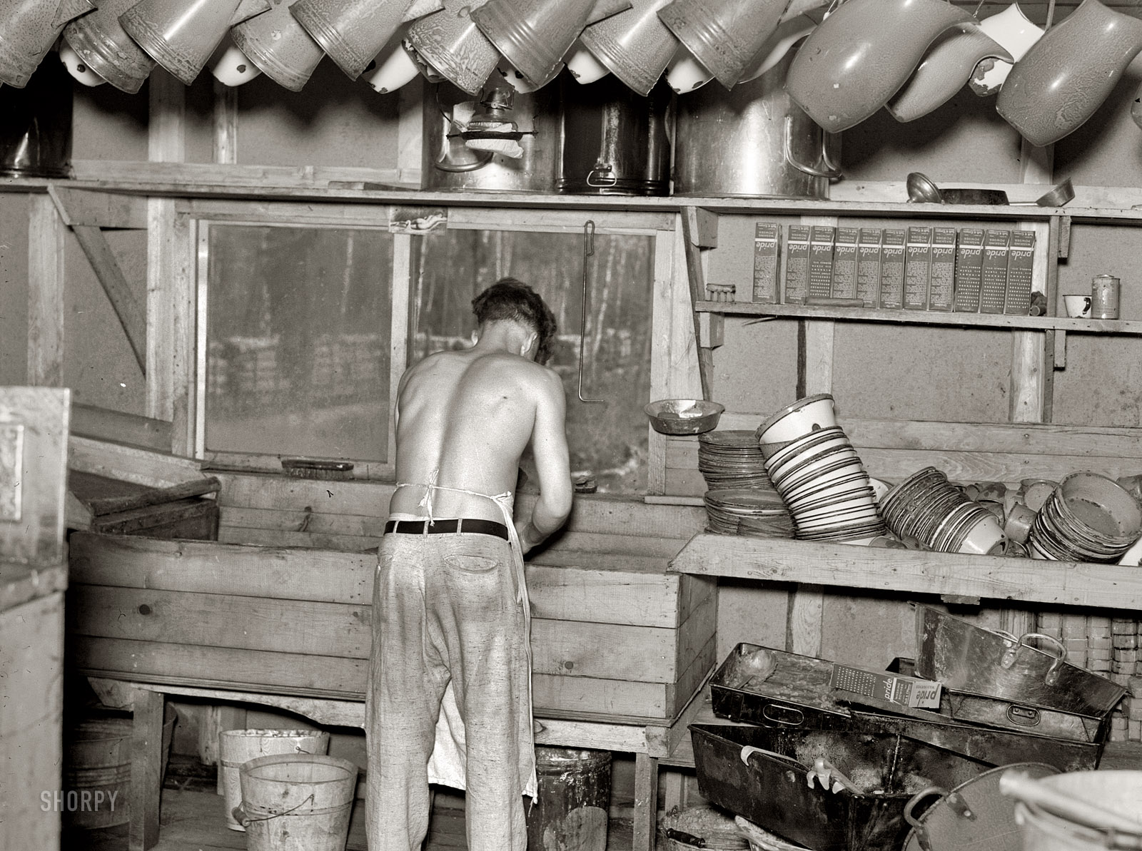 September 1937. Effie, Minnesota. "Washing dishes in lumber camp." Medium format negative by Russell Lee, Farm Security Administration. View full size.