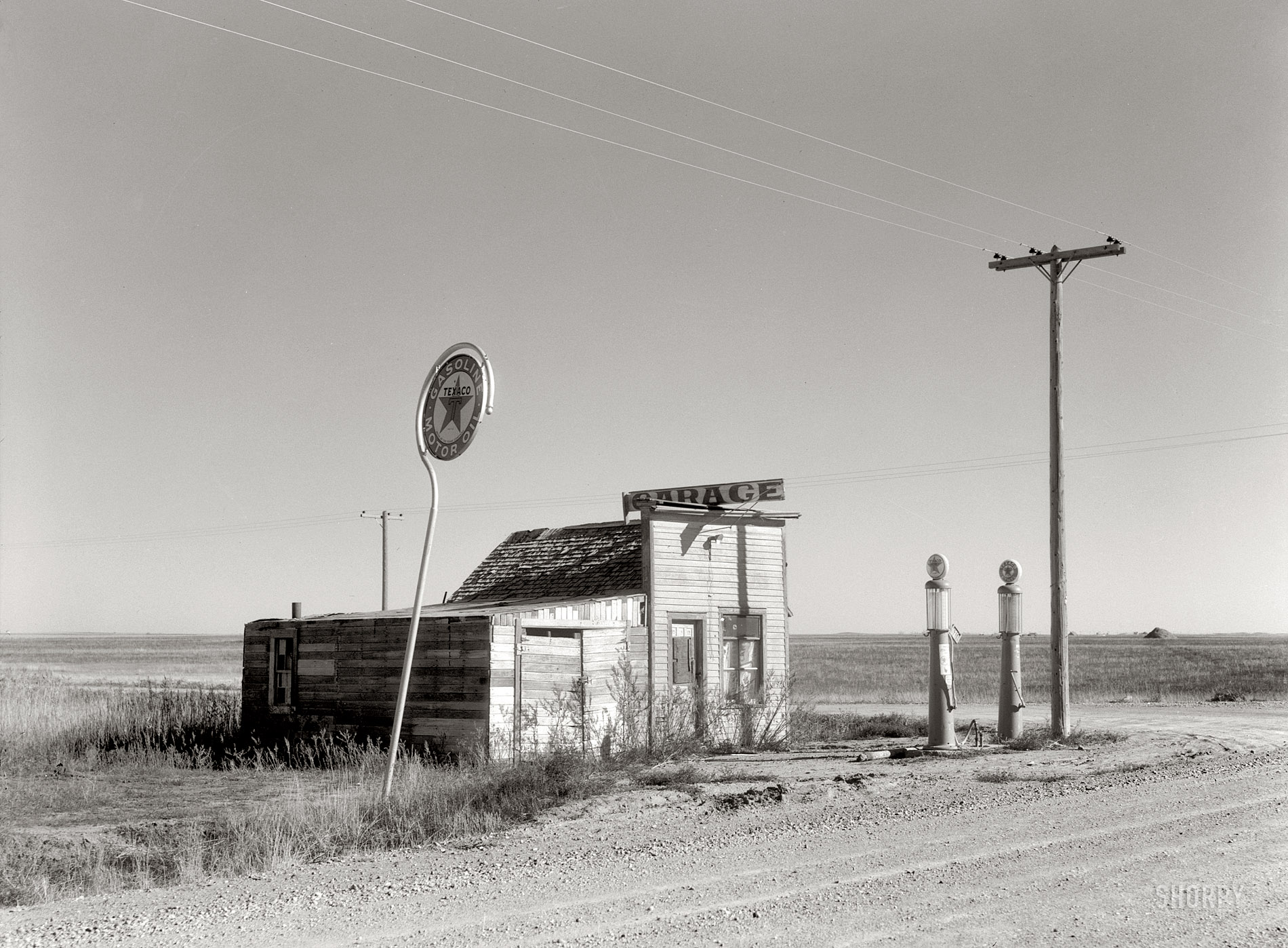 October 1937. "Abandoned garage on Highway No. 2. Western North Dakota." Medium format safety negative by Russell Lee for the FSA. View full size.