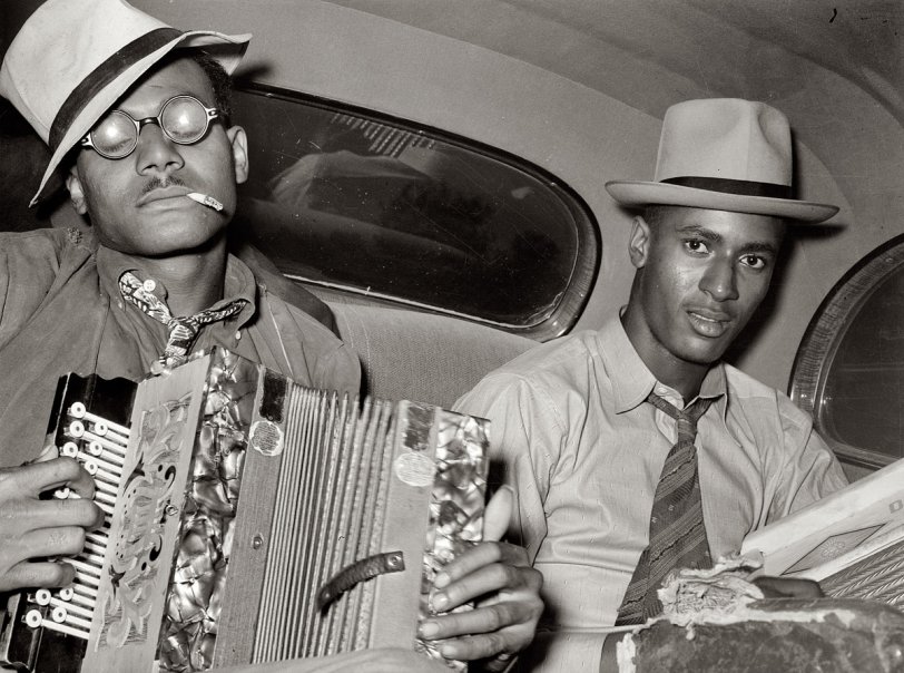 October 1938. "Negro musicians playing accordion and washboard in automobile. Near New Iberia, Louisiana." View full size. Medium format negative by Russell Lee for the Farm Security Administration. This natty duo can also be seen here.
