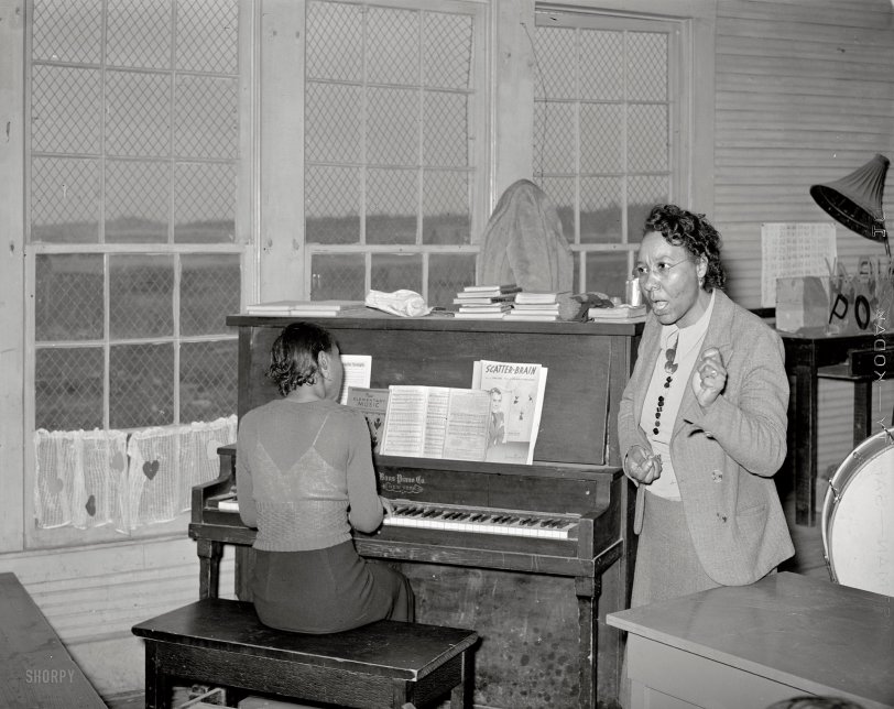 February 1940. Vernon, Oklahoma. "Song director conducting singing of spiritual at soil conservation meeting." Medium format acetate negative by Russell Lee for the Farm Security Administration. View full size.
