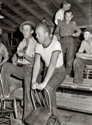 May 1940. "Young migratory agricultural workers singing at the Saturday night dance. Agua Fria migratory labor camp, Arizona." View full size. Medium format negative by Russell Lee for the Farm Security Administration.