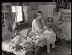 Interior of Ozarks cabin housing six people in Missouri. May 1936. View full size. Farm Security Administration photograph by Carl Mydans.