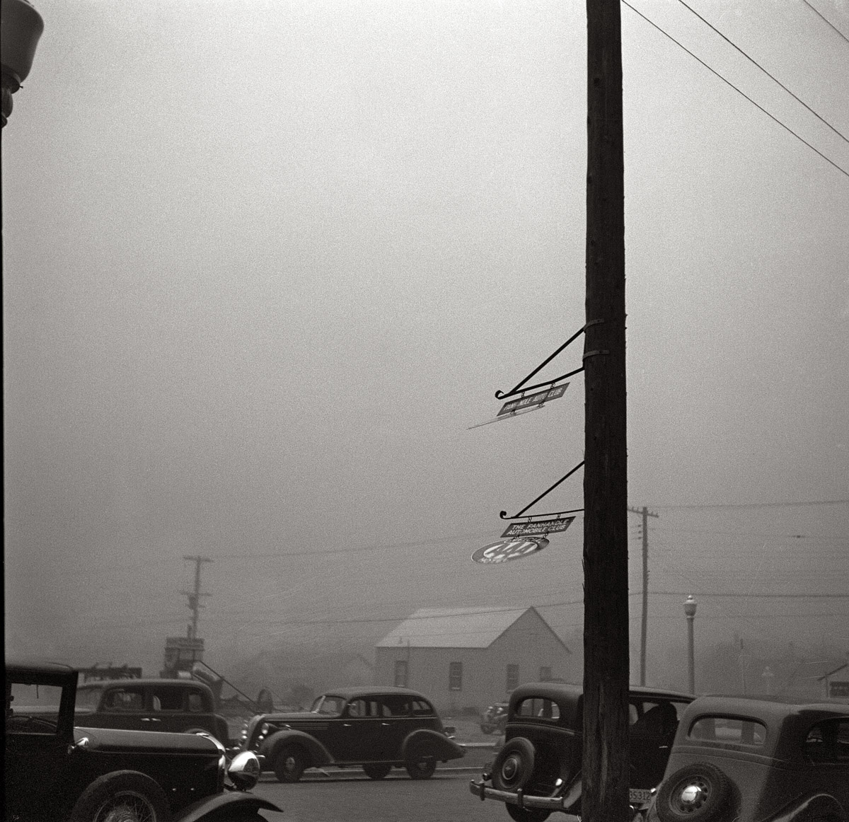 April 1936. "Dust storm. Note heavy metal signs blown out by wind. Amarillo, Texas." Medium format nitrate negative by Arthur Rothstein. View full size.