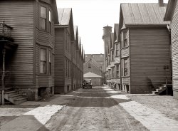 April 1936. View from living quarters at 730 West Winnebago Street, looking back down the alley. Milwaukee, Wisconsin. View full size. Photo by Carl Mydans.