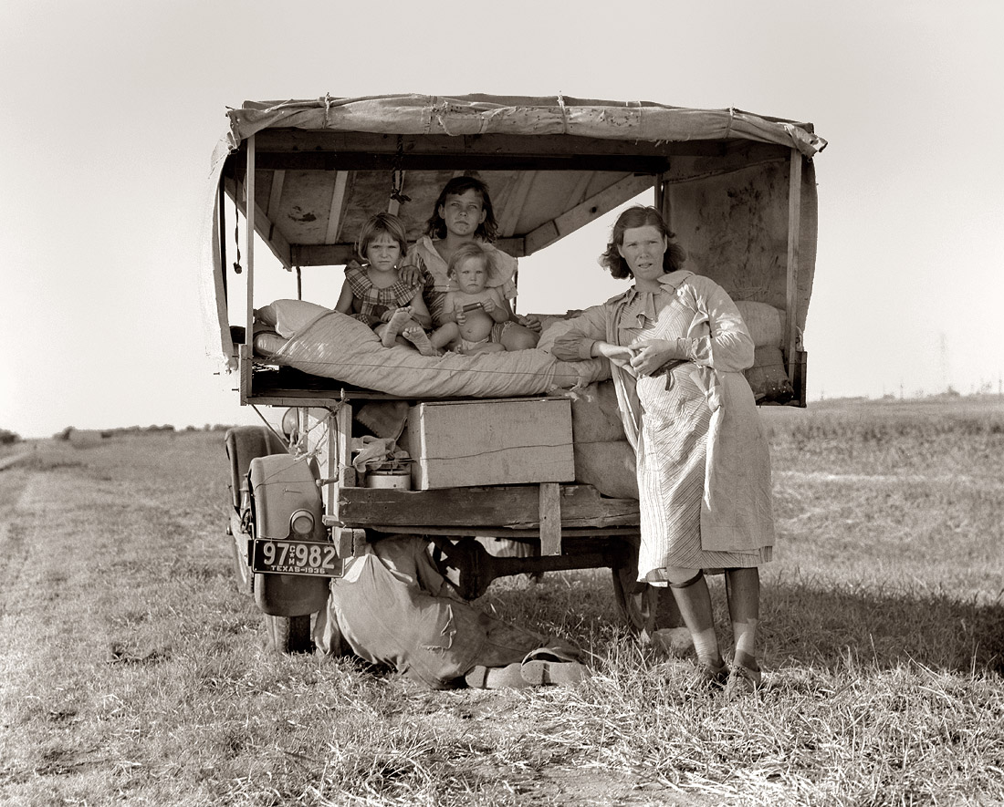 August 1936. Family between Dallas and Austin, Texas. The people have left their home and connections in South Texas, and hope to reach the Arkansas Delta for work in the cotton fields. Penniless people. No food and three gallons of gas in the tank. The father is trying to repair a tire. Three children. Father says, "It's tough but life's tough anyway you take it." View full size. Photo by Dorothea Lange.