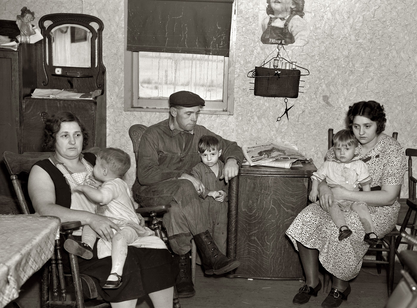 December 1936. Dickens, Iowa. "Part of the L.H. Nissen family of ten living in a three-room shack. Rest of family at school. The whole house was of unusually high humidity. The wife said they could not dry out the bedding because of the poor ventilation. This is the living room and kitchen combined." View full size. Medium format negative by Russell Lee for the Resettlement Administration.