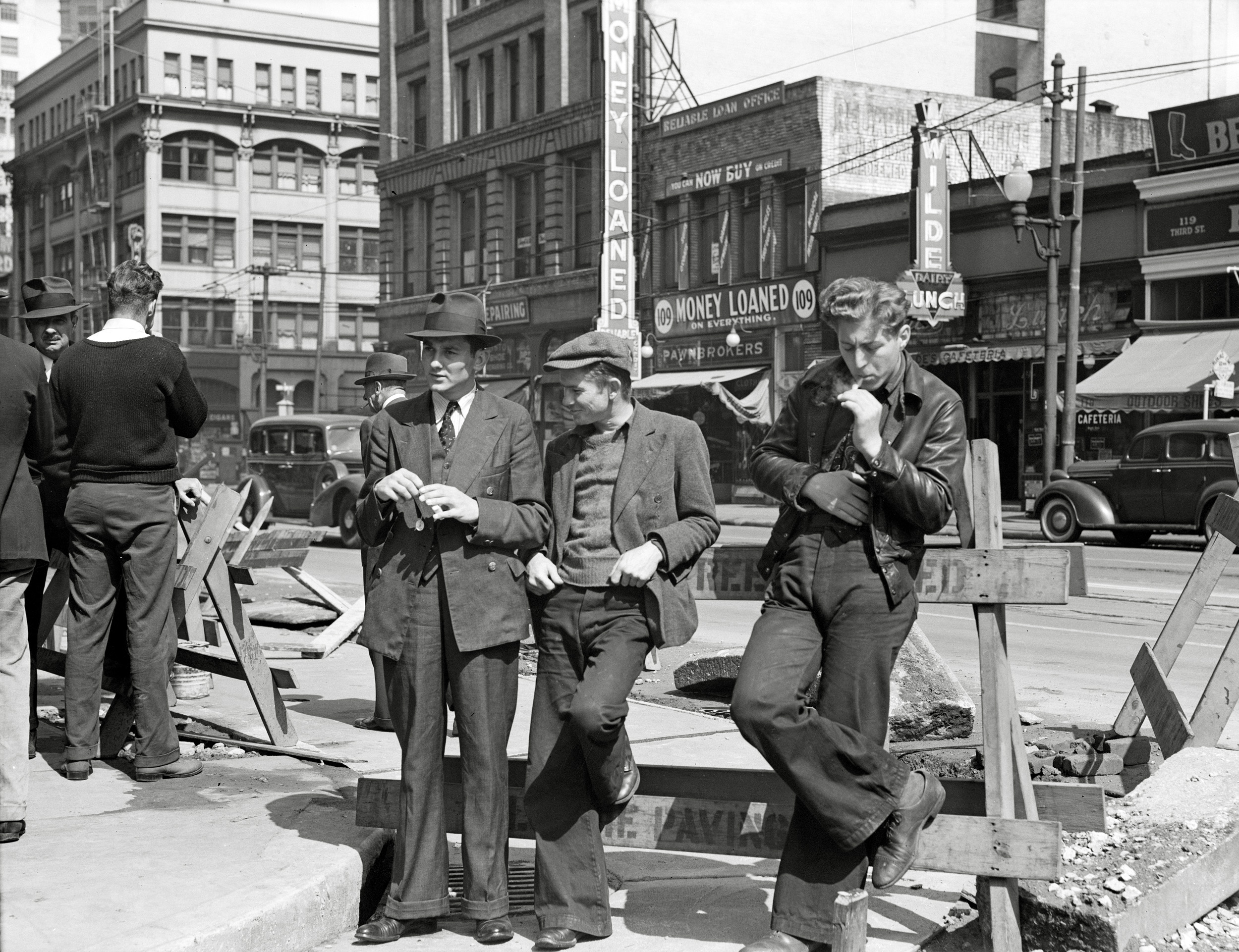 April 1939. "Salvation Army, San Francisco, California. Unemployed young men pause a moment to loiter and watch, and then pass on." Large format nitrate negative by Dorothea Lange. View full size. 