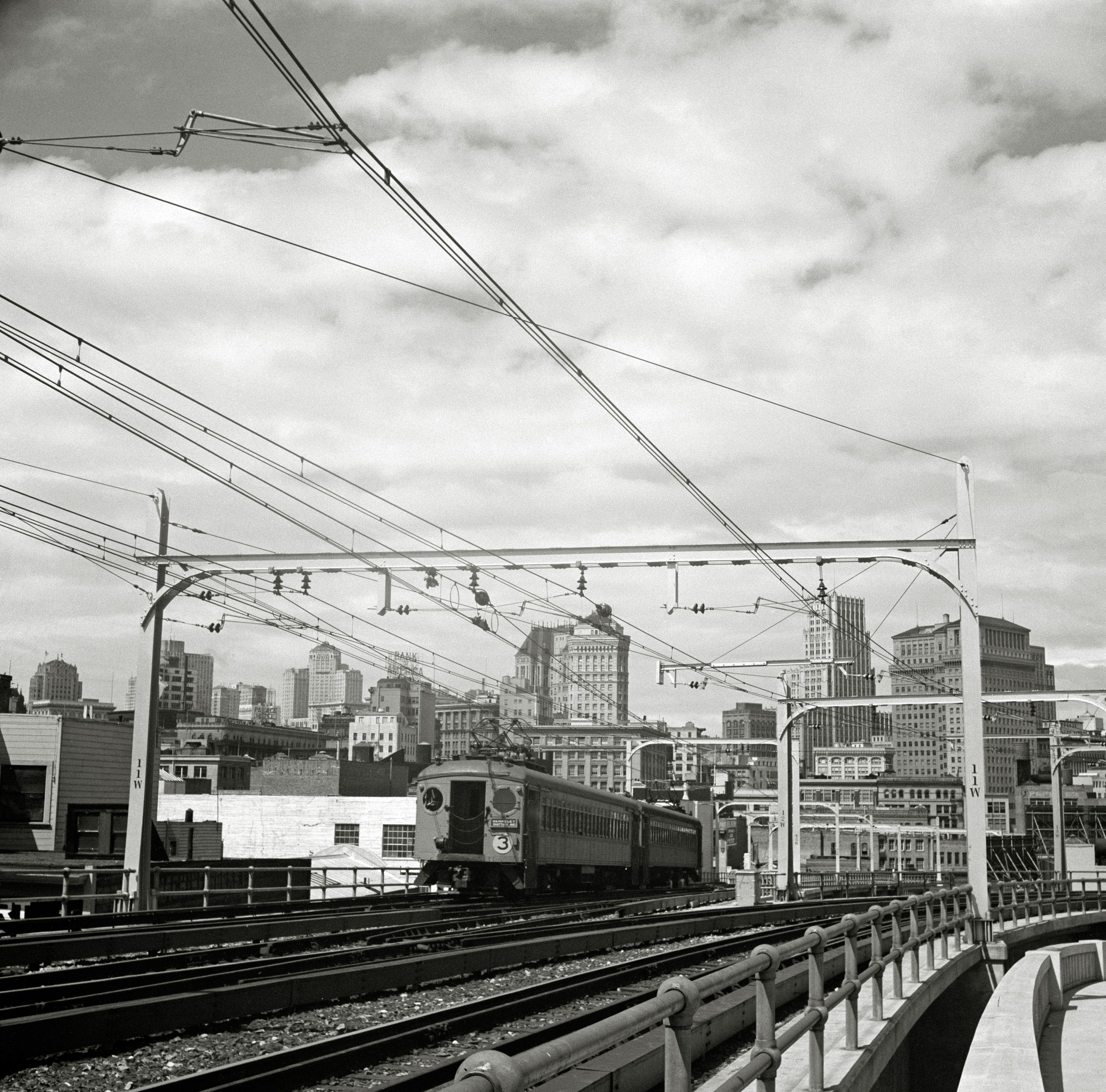 April 1939. "San Francisco, California, seen from the First Street ramp of the San Francisco-Oakland Bay Bridge." Before BART (Bay Area Rapid Transit) crossed the bay, there was the Key System. Photo by Dorothea Lange. View full size.