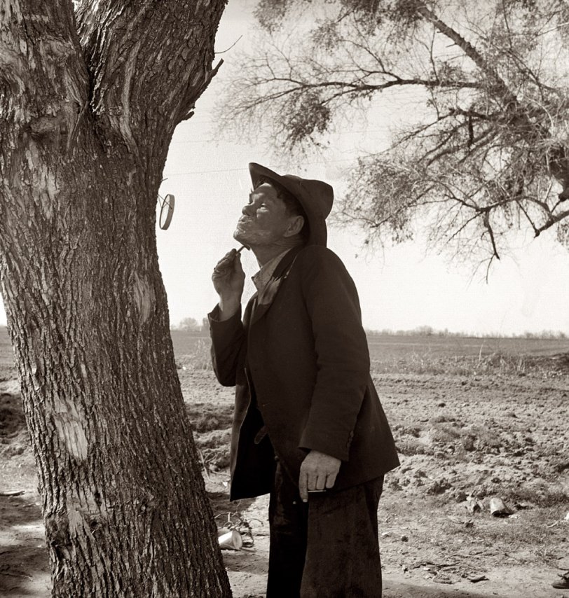 February 1939. "On U.S. 99 between Bakersfield and the Ridge, en route to San Diego. Migrant man shaving by roadside." View full size. Medium-format nitrate negative by Dorothea Lange for the Farm Security Administration.

