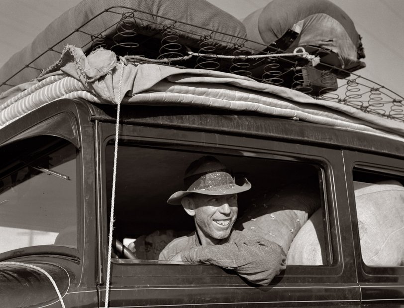 May 1939. Between Tulare and Fresno on U.S. 99. Farmer from Independence, Kansas, on the road at cotton chopping time. He and his family have been in California for six months. View full size. Photograph by Dorothea Lange.

