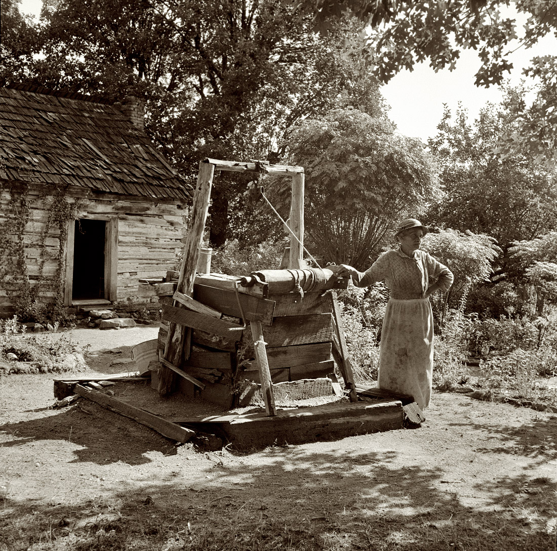 July 1939. Orange County, North Carolina. "Caroline Atwater, wife of Negro landholder, in the yard of her double one-and-a-half-story log house, telling where she was born and how she came to this place." View full size.  Medium-format nitrate negative by Dorothea Lange for the Farm Security Administration.