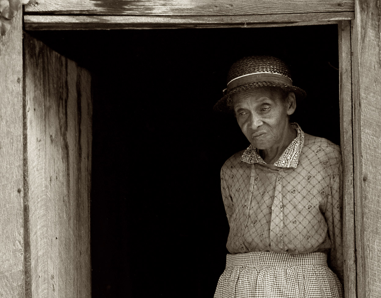 A closeup of Caroline Atwater, seen earlier this week, in the doorway of her kitchen in Orange County, North Carolina. View full size.  Medium-format nitrate negative by Dorothea Lange for the Farm Security Administration.