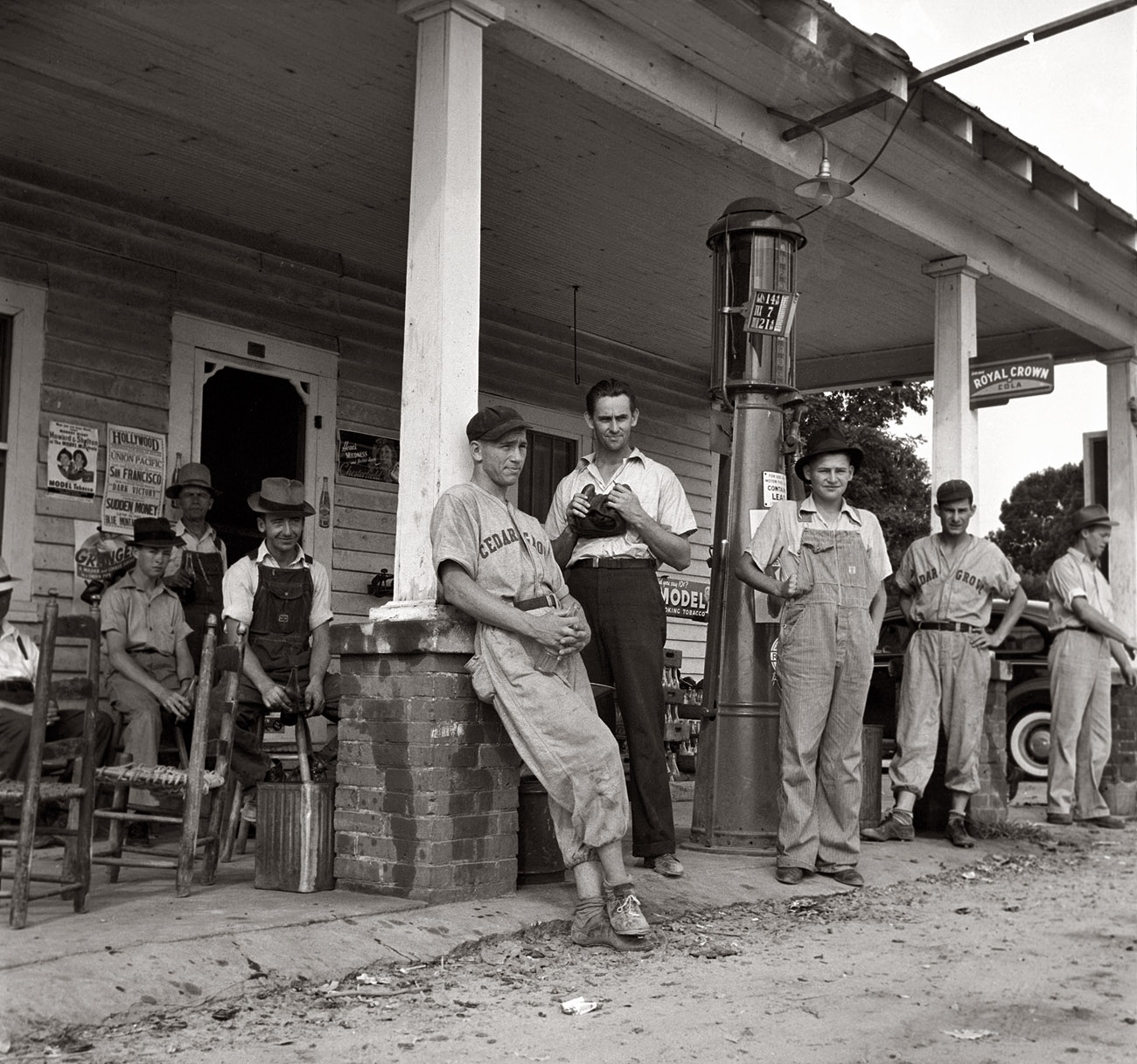 Fourth of July 1939 near Chapel Hill, North Carolina. "Rural filling stations become community centers and general loafing grounds. Cedargrove Team members about to play in a baseball game." Medium-format nitrate negative by Dorothea Lange. View full size.
